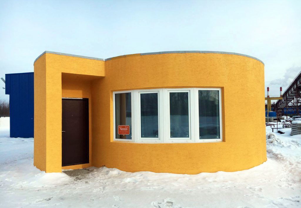 Exterior of the 3D printed, then painted Apis Cor house. Photo via Apis Cor