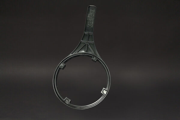 black and white photo of a pair of scissors next to an industrial ultrasonic cleaner and a Filter Wrench