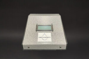 silver Omega Watt + Frequency Validator - 40 kHz electronic device on a black background